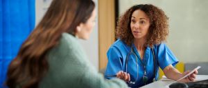 Black female healthcare provider talks to a female patient about antidepressant withdrawal