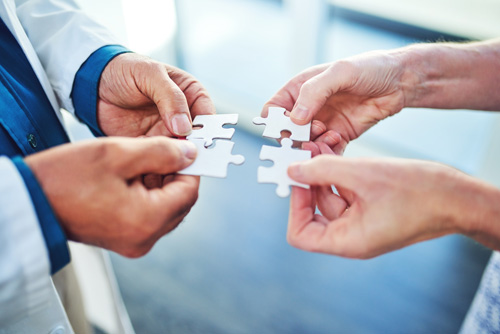 A doctor and patient holding puzzle pieces to find the right antidepressant
